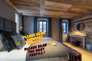 a bedroom with a bed with writing on it at Luxuryy Chalet - Megeve - with Pool&HotTub in Megève +9 photos