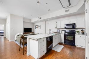 a kitchen with white cabinets and a counter top at New Downtown JC Loft! in Johnson City
