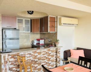 a kitchen with a counter and a table with chairs at Pyramids Terrace INN in Cairo