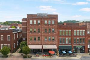 a large red brick building in a city at New Downtown JC Loft! in Johnson City