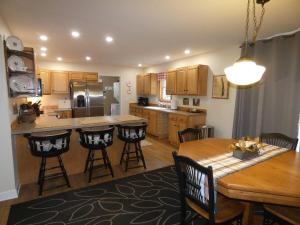 a kitchen with a wooden table and chairs and a dining room at Woodland Retreat At Finch Creek in Bellaire