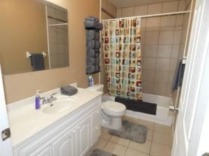 a bathroom with a sink and a toilet and a shower at Woodland Retreat At Finch Creek in Bellaire +34 photos
