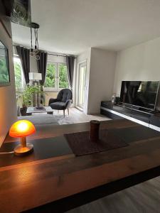 a living room with a large flat screen tv at Moderne 75m2 Wohnung mit Balkon und Blick ins Grüne in Magdeburg