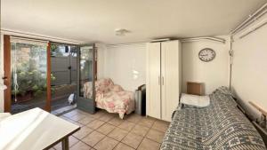 a bedroom with a bed and a clock on the wall at Cozy Lilas in Heusenstamm +1 photo