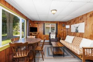 a living room with a couch and a table at 7 Cabins & A House on Chippewa Lake in Chippewa Lake