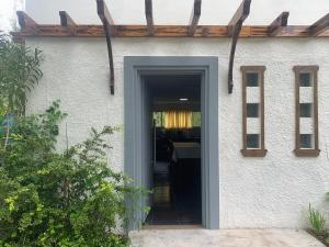 a door leading into a house with a porch at Casa en La Caleta Normandita in Mar de Cobo