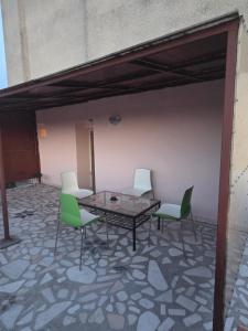 a patio with a table and four chairs at Apartament MATEI in Timişoara