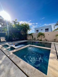 a swimming pool in the backyard of a house at Luxury Private Villa At Metro Pool Jacuzzi Wifi Sleeps 10 in Juan Dolio