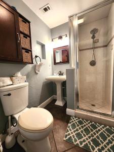 a bathroom with a toilet and a shower and a sink at Private Oasis!Bike to beach, heated pool in Naples
