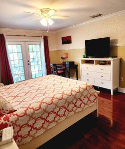 a bedroom with a bed and a flat screen tv at Private Oasis!Bike to beach, heated pool in Naples
