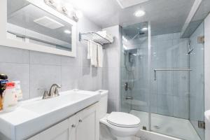 a bathroom with a toilet and a sink and a shower at Bloor Hotel - Modern Suite Condo Heart Of St Clair West in Toronto