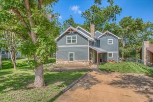 a house with a tree in the yard at Down River Haus LD 727 in New Braunfels