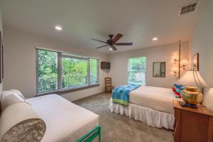 a bedroom with two beds and a ceiling fan at Down River Haus LD 727 in New Braunfels