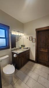 a bathroom with a toilet and a sink at Parkside Cabins in West Yellowstone +17 photos