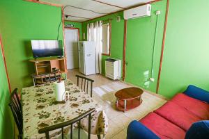 a living room with a table and a couch at Cabaña familiar cerca del mar en Caleta Olivia in Caleta Olivia