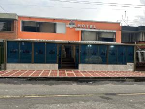 an orange building with a hotel on the street at Aw Hotel Ariston Embassy in Bogotá