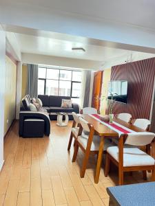 a living room with a table and a couch at Depamia in Huaraz