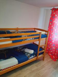 a bedroom with two bunk beds with blue sheets at Maison familiale EXCELLENCE,3 chambres jardin avec jeux, proche gare Bourg en Bresse in Saint-Denis-lès-Bourg
