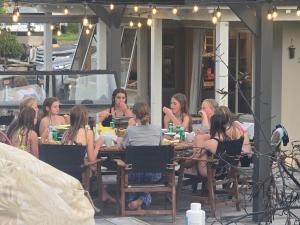 a group of women sitting at a table on a patio at The Bluffs Villa in Queenstown