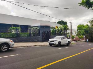a white truck parked on the side of a street at Kartagus Centric in San Salvador
