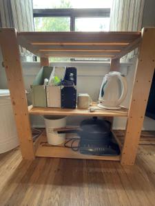 a wooden shelf with dishes and other items on it at Ophelias Casa in Vancouver