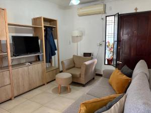 a living room with a couch and a chair and a television at Casa Rita in Gualeguaychú