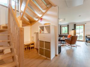 a living room with a staircase and a dining room at Chalet Amsel in Donnersbachwald