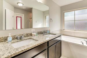 a bathroom with two sinks and a large mirror at 9 Mi to College Station Dog-Friendly Home with Yard in Bryan +16 photos