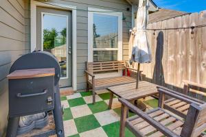 a porch with a picnic table and a grill and a bench at 9 Mi to College Station Dog-Friendly Home with Yard in Bryan