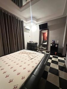 um quarto com uma cama e um piso xadrez em Motel Vitoria Reggia em São Vicente