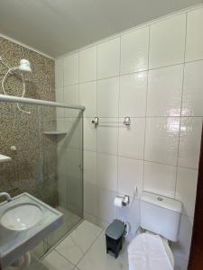 a bathroom with a toilet and a sink at Pousada Japaratinga Good Vibes in Japaratinga
