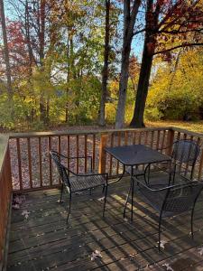 a table and two chairs on a wooden deck at PSU 2br 2ba Townhome w Parking Near Campus and Stadium in Park Forest Village