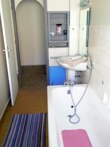 a bathroom with a bath tub and a sink at Themis by Welcome to Cannes in Cannes