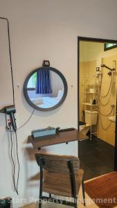 a room with a mirror and a table and a bed at Choose from 3 Distinct Character Houses with Soft Beds, Cozy Balconies and Bonuses in Haad Pleayleam