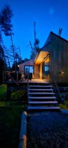 a house with stairs in front of a building at Henko 1 in Villa La Angostura