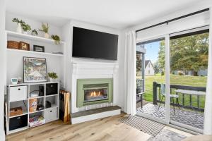 a living room with a fireplace and a tv at King Bed, Walk or Bike to town, EV, Pets OK in Ellicottville +26 photos