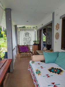 a living room with a couch and a table at Choose from 3 Distinct Character Houses with Soft Beds, Cozy Balconies and Bonuses in Haad Pleayleam