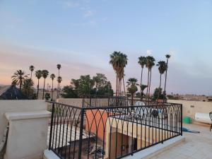 a view of palm trees from a balcony at Riad Al Mechouar in Marrakech