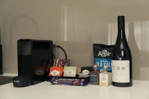 a bottle of wine sitting on a counter next to a microwave at 429 Apartments & Suites in Hobart