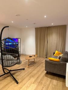 a living room with a couch and a table at Cozy one Bedroom with Views In Birmingham City Center in Birmingham