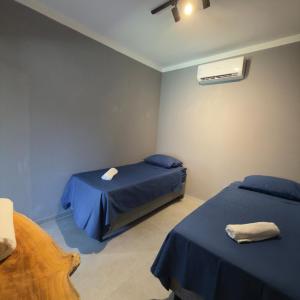 a bedroom with two beds and a air conditioner at Bangalô Miramar Maragogi in Maragogi +47 photos