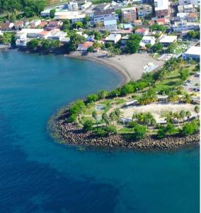an aerial view of a small island in the water at Lagoon Studio Plage in Schœlcher