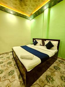 a bed in a room with green walls at Suryakulam palace in Ayodhya +31 photos