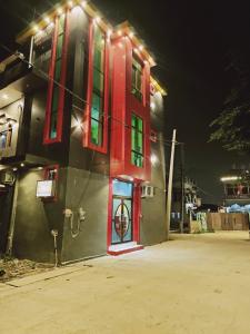 a building with a red door and lights on it at Suryakulam palace in Ayodhya
