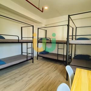 a room with four bunk beds in it at Woke Coliving Kanlaon in Manila