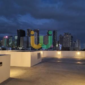 a view of a city skyline at night at Woke Coliving Kanlaon in Manila