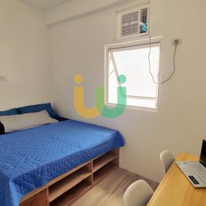 a bedroom with a bed and a window and a desk at Woke Coliving Kanlaon in Manila +5 photos