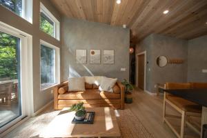 a living room with a couch and a table at Cozy Luxury Cabin w Hot Tub, Fire Pit, King Bed in Newry