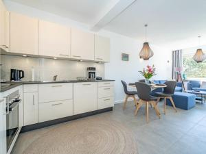 a kitchen and living room with a table and chairs at One-bedroom apartment in Westerland (Sylt)