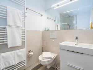 a bathroom with a sink and a toilet and a mirror at One-bedroom apartment in Westerland (Sylt) +9 photos
